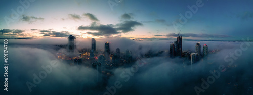 Residential Apartment home Buildings covered in fog at winter sunrise. Modern Cityscape photo