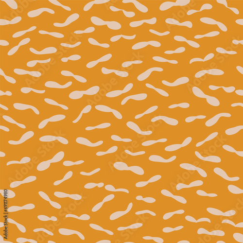 Yellow pattern of hand drawn peanut shapes inspired in African safari prints. Vector seamless pattern design for textile, fashion, paper, packaging and branding
