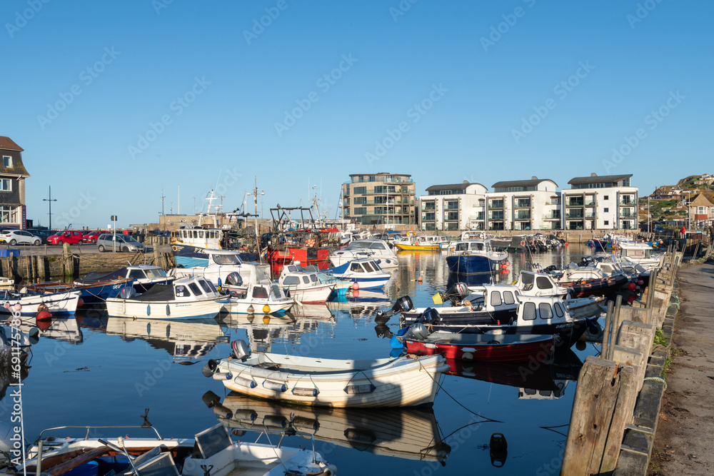 Photo of fishing boats moored in West Bay harbour in Dorset