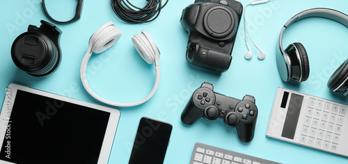 Different modern devices and gadgets on light blue background photo