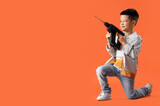 Cute little worker with drill on orange background