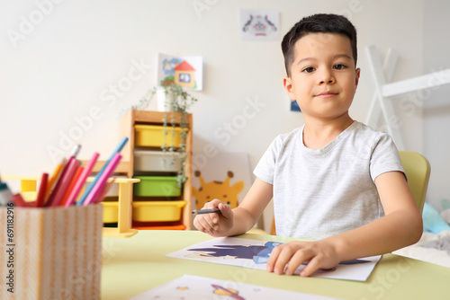 Little Asian boy drawing at...