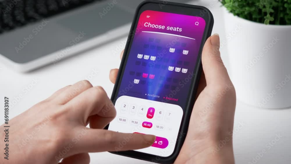Buying cinema tickets online. Choosing seats in movie theater and buying tickets using app for mobile phone.