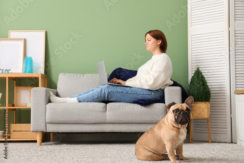Cute dog and owner using laptop at home © Pixel-Shot