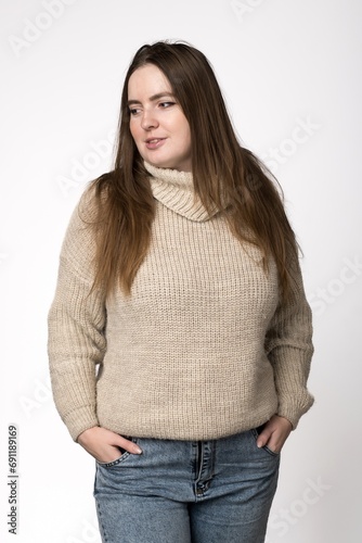 portrait of a girl of Slavic appearance in a milk sweater on white