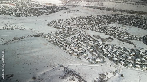 Aerial of snowy neighborhood with snowy fields of open space near Denver Colorado on sunny winter day photo