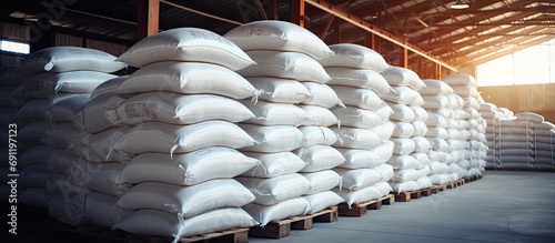 Chemical fertilizer urea stock piles of big jumbo bags loaded on trailers parked in warehouses awaiting delivery. Copy space image. Place for adding text photo