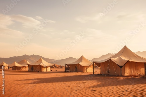 camping tents in the middle of the desert with the mountains at back