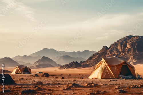 camping tents in the middle of the desert with the mountains at back