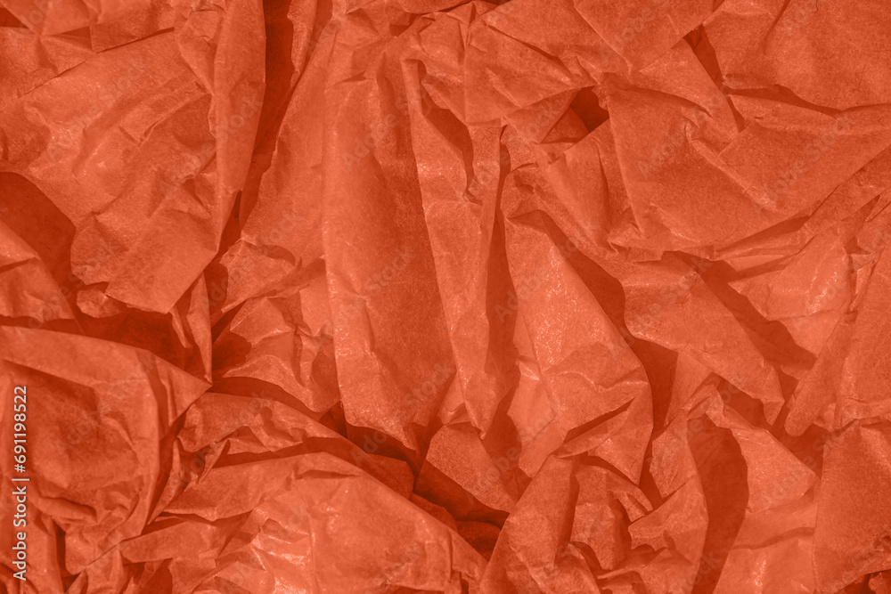 Crumpled paper Peach Fuzz color of the year 2024. Texture crumpled paper for design. Peach background. Trendy abstract wallpaper.