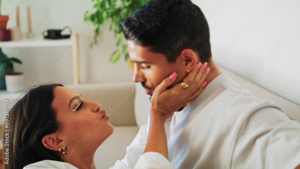 Romantic lovers kissing white interior closeup. Couple smiling enjoying together Romantic lovers kissing white interior closeup. Couple smiling enjoying together