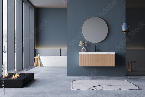 Modern bathroom interior with winter concept, white bathtub and chic vanity, black walls, parquet floor, plants, natural lighting. Minimal bathroom with modern furniture photo