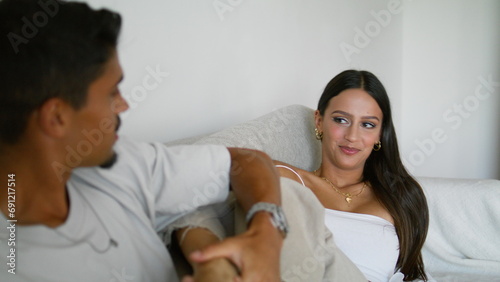 Gentle man massaging wife legs hotel room closeup. Newlyweds spending honeymoon