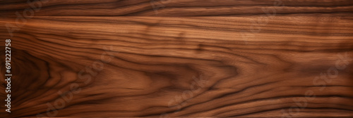 Walnut tree texture close up. Wide walnut wood texture background. Walnut veneer is used in luxury finishes. photo