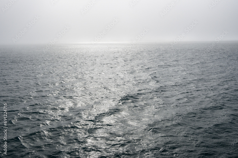 Peaceful early morning fog over the arctic ocean, water to the foggy horizon, as a nature background
Peaceful early morning fog over the arctic ocean, water to the foggy horizon, as a nature background
