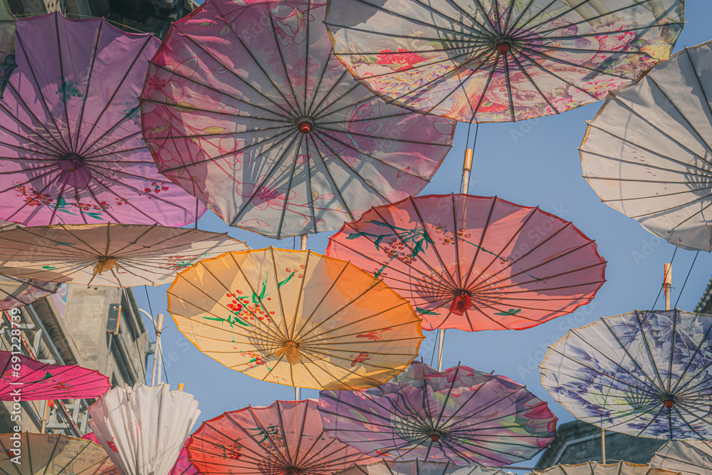 Naklejka premium Vibrant colorful Chinese style umbrellas at the umbrella street in Hohhot, China