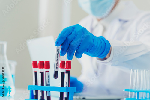 Close up Doctor clinic healthcare technician lab testing blood sample diagnosis. Crop man scientist hands testing medical lab. Scientist man hands holding sample blood test tube science laboratory. photo