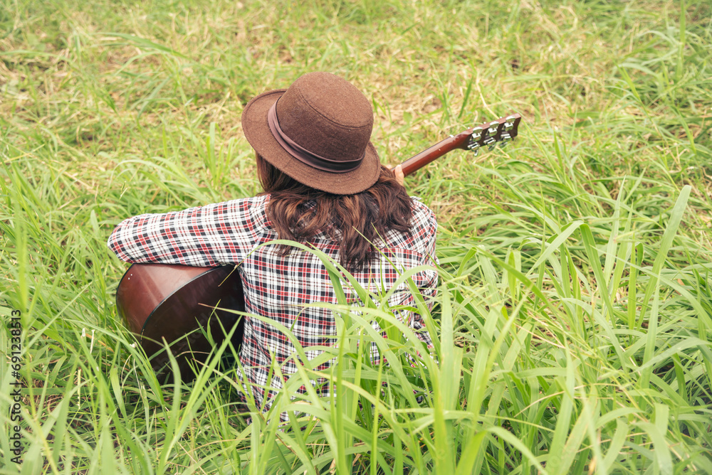 Young women playing acoustic guitar outdoor in green park. Woman person playing acoustic guitar music instrument at home, young Asian musician girl lifestyle in beautiful nature. Happy guitarist Young women playing acoustic guitar outdoor in green park. Woman person playing acoustic guitar music instrument at home, young Asian musician girl lifestyle in beautiful nature. Happy guitarist
