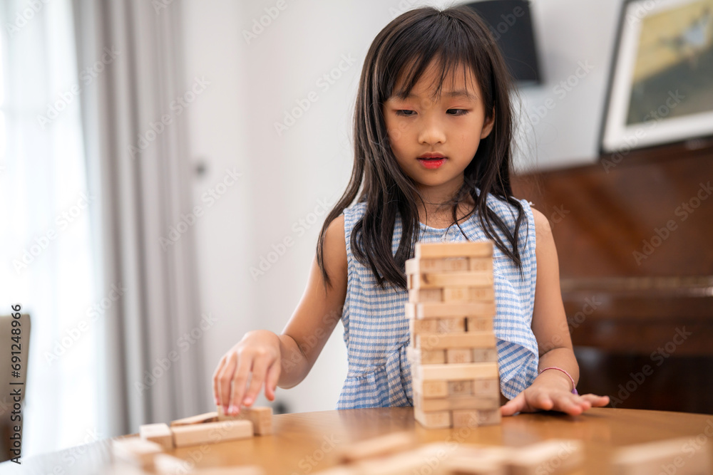 Portrait happy little asian girl learn and study.student, development, leisure, school, kid, child.young girl play activity skill brain training play with toy build wooden blocks board education game Portrait happy little asian girl learn and study.student, development, leisure, school, kid, child.young girl play activity skill brain training play with toy build wooden blocks board education game