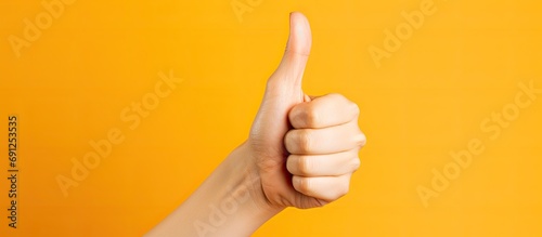Woman thumbs up with hyper-flexible hand. photo
