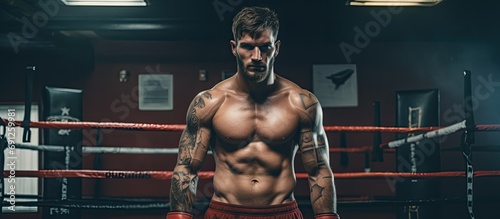 Boxer with strong physique training in boxing club. © AkuAku