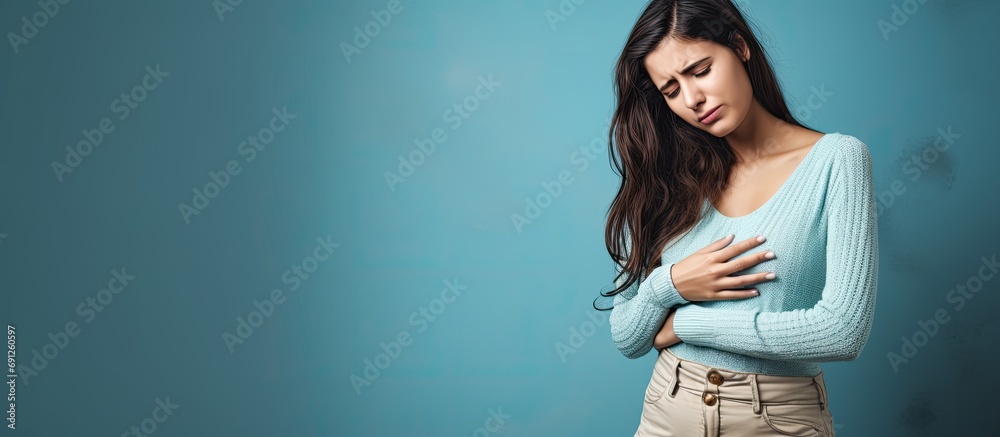 Woman experiencing abdominal discomfort and stomach cramping. - obrazy, fototapety, plakaty 