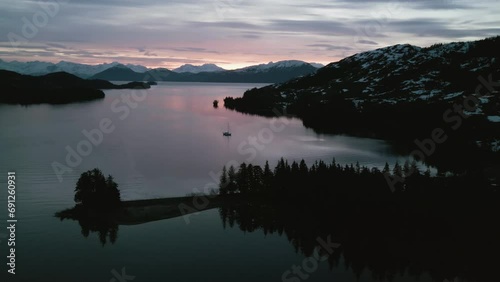 Aerial view around a sailboat moored in the West Twin Bay, gloomy dusk in Alaska photo