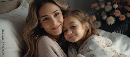 European mother and daughter bonding, cuddling at home.