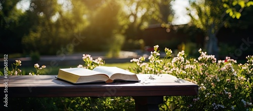 Bible on table in garden. photo