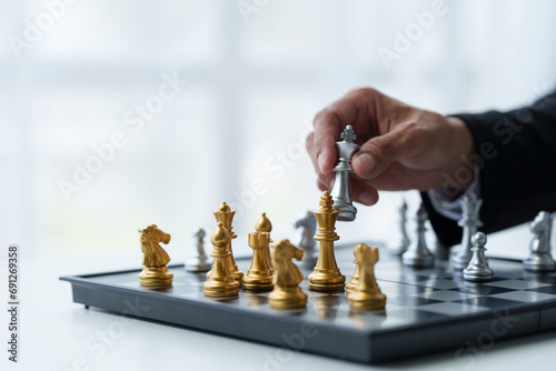 Businessman's hands move chess figures and checkmate opponent during match. Strategy, management, business planning, disruption and leadership concepts analyze development for organizational success.