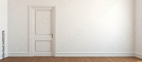 An unoccupied room with white walls and wooden flooring containing a doorway to another room.