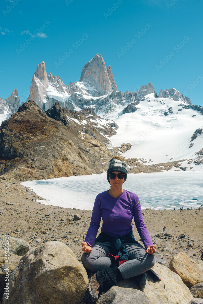 young lady posing in the iconic view of fitzroy mountain close to a lake