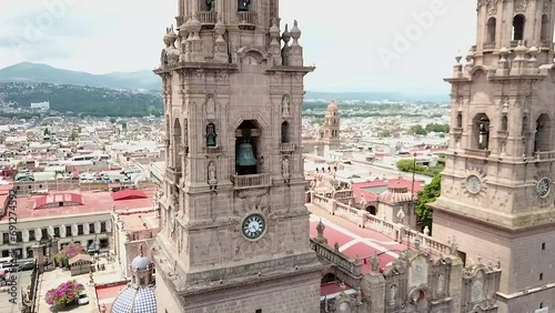 Bell towers of the Cathedral of Morelia during the ringing of the bells photo