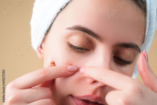 Pustule acne. Close up pimple on female skin. Dermatology, puberty woman, skin reaction from cosmetic, rash on face. Skin problem. Woman Touching Pimple On Skin. Facial Skincare.