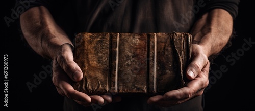 Worn Bible held by man.
