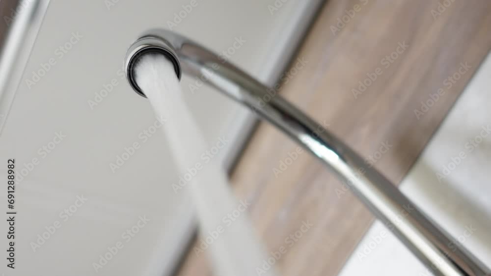 Water dripping from faucet tap at kitchen. Closeup Water dripping from faucet tap at kitchen. Closeup