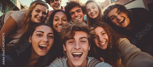 Happy young teens taking a group selfie.
