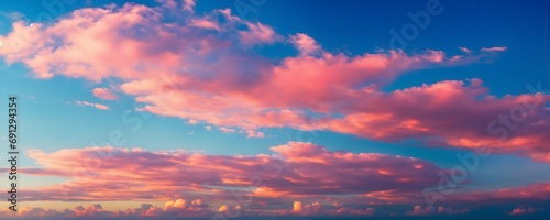 Psatel pink clouds on blue sky background.