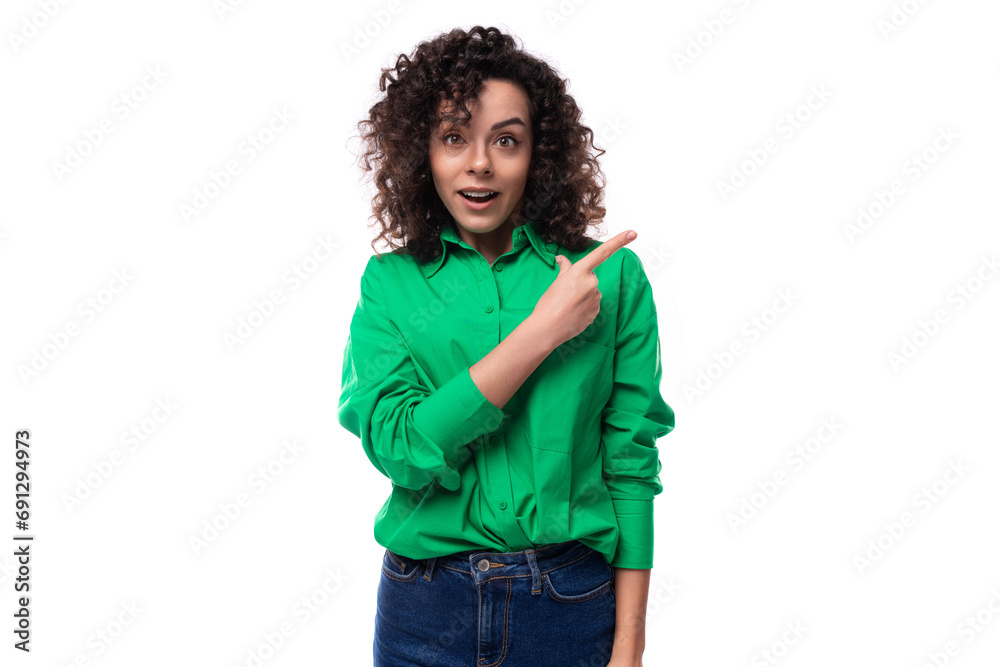 a young woman with a stylish hair styling in a curly method demonstrates with her hand an empty space for advertising a young woman with a stylish hair styling in a curly method demonstrates with her hand an empty space for advertising