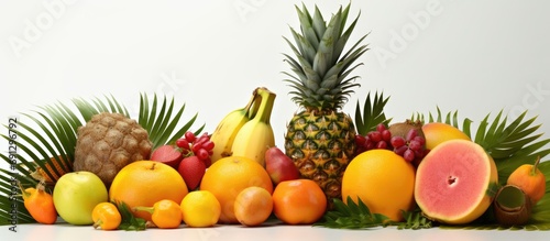 Assorted tropical fruits including coconut, mango, papaya, corambola, and pineapple. photo