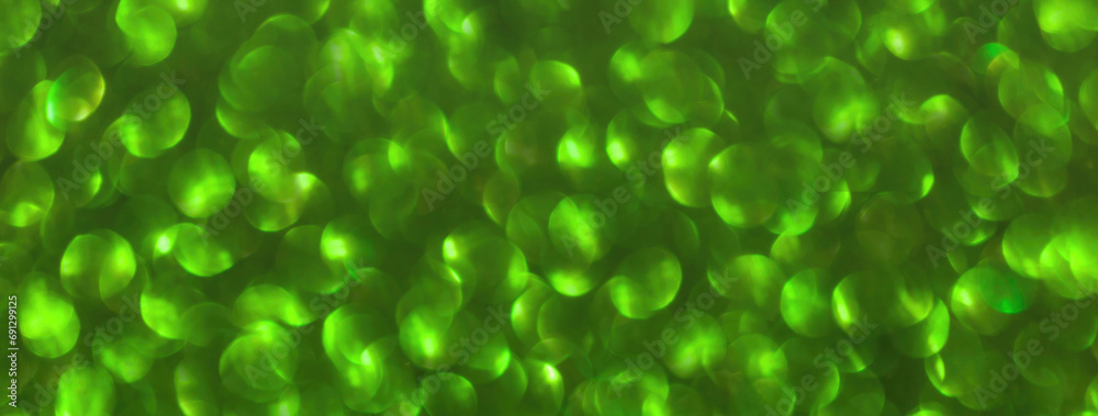 Blurred green sparkling background from sequins, macro. Shiny glittery bokeh of christmas garland. Blurred green sparkling background from sequins, macro. Shiny glittery bokeh of christmas garland.