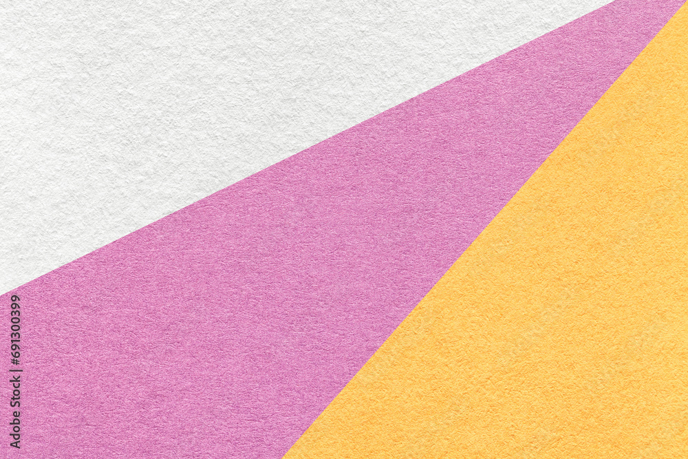 Fototapeta premium Texture of old craft white, pink and yellow color paper background, macro. Vintage abstract purple cardboard