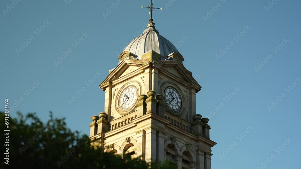 Traditional clock tower monument with weather vane in Buxton, Peak District, UK Traditional clock tower monument with weather vane in Buxton, Peak District, UK