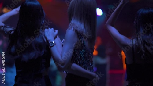 backview slow motion VDO. Sexy young woman people and friends dancing in night club. Nightlife and disco dance party concept. music festival. Cheerful Happy fun Asian thai people dance in night club