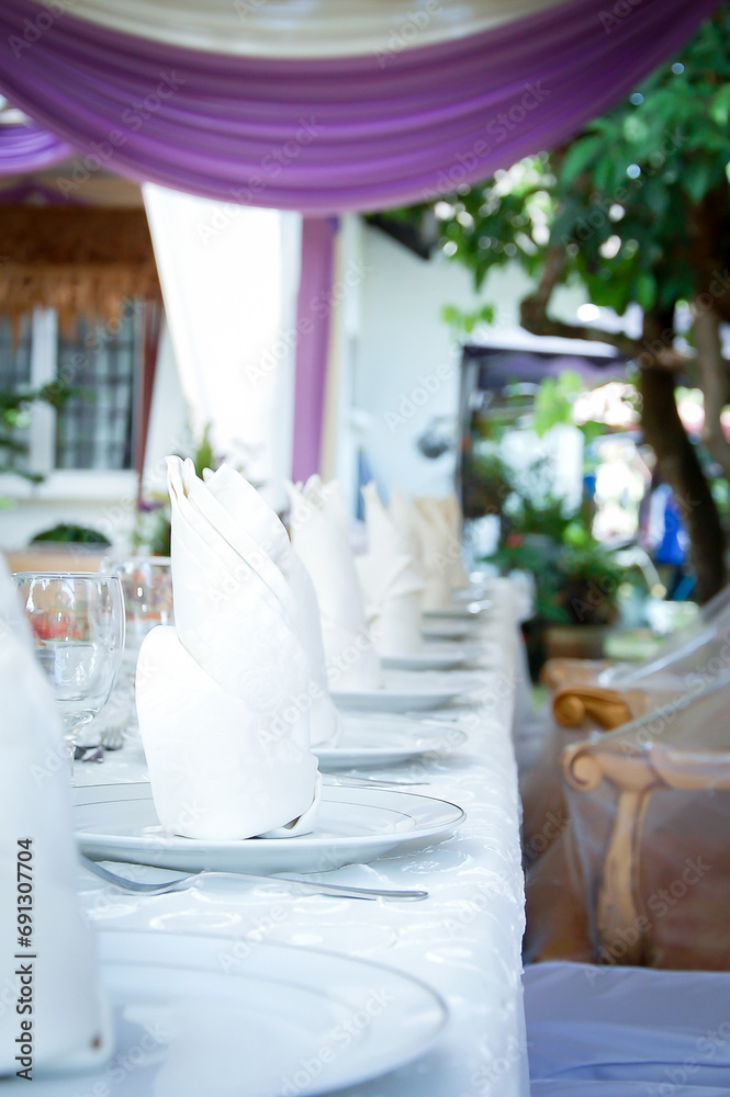 Table set for wedding or another catered event lunch. Wedding catering decor.