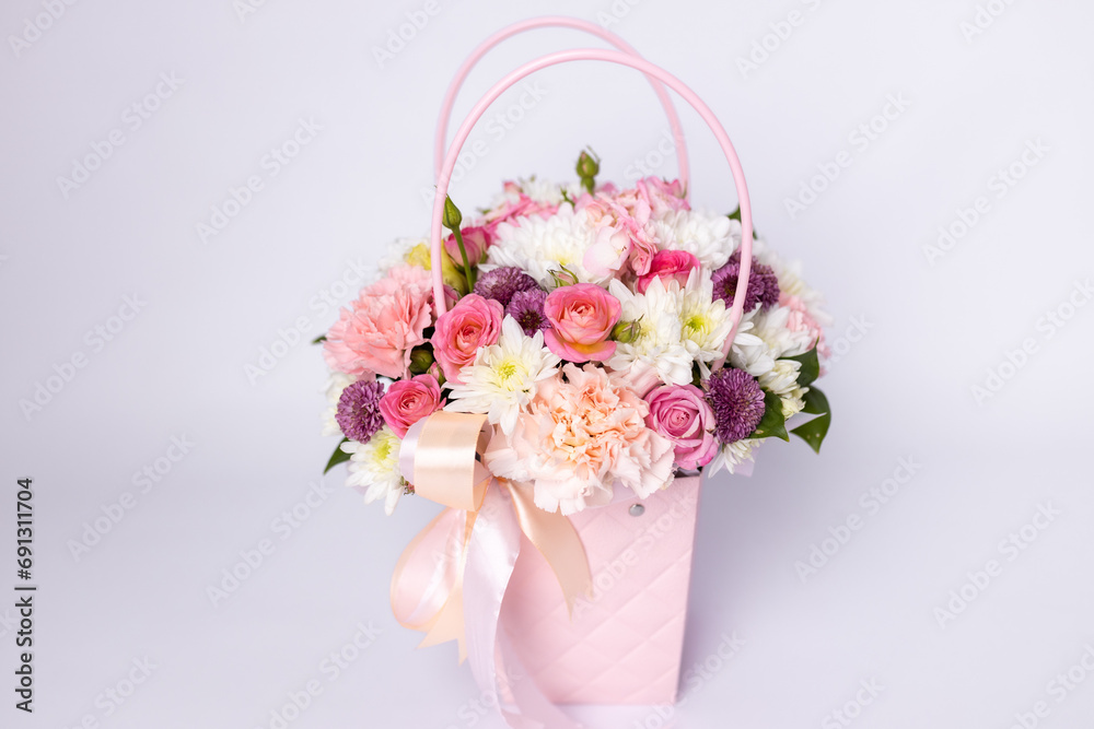 Beautiful bouquet of flowers in pink box on a white background. Gift for holiday, birthday, Wedding, Mother's Day, Valentine's day, Women's Day. Floral arrangement in a hat box Beautiful bouquet of flowers in pink box on a white background. Gift for holiday, birthday, Wedding, Mother's Day, Valentine's day, Women's Day. Floral arrangement in a hat box