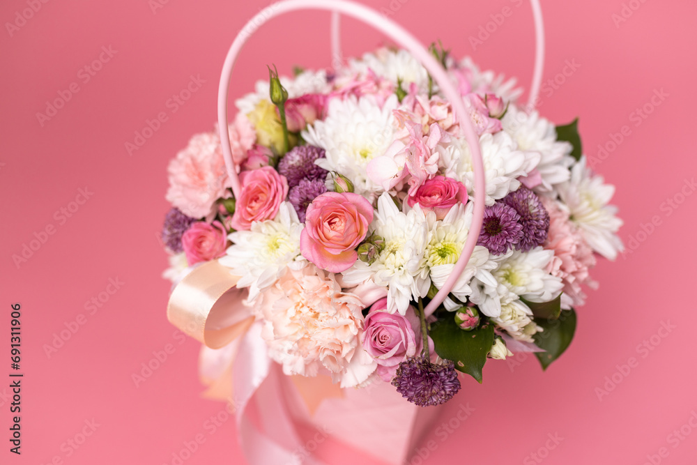Beautiful bouquet of flowers on a pink background. Gift for holiday, birthday, Wedding, Mother's Day, Valentine's day, Women's Day. Floral arrangement in a hat box