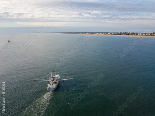 Fishing boat in calm waters off the coast of North Carolina USA in the Atlantic from above