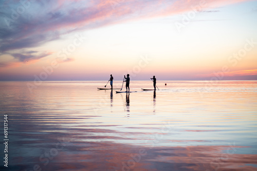 Paddle Boarding at sunset with pink sky