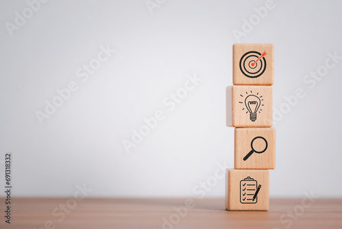 Wood cube block stacking with icon. business strategy and action plan Concept.